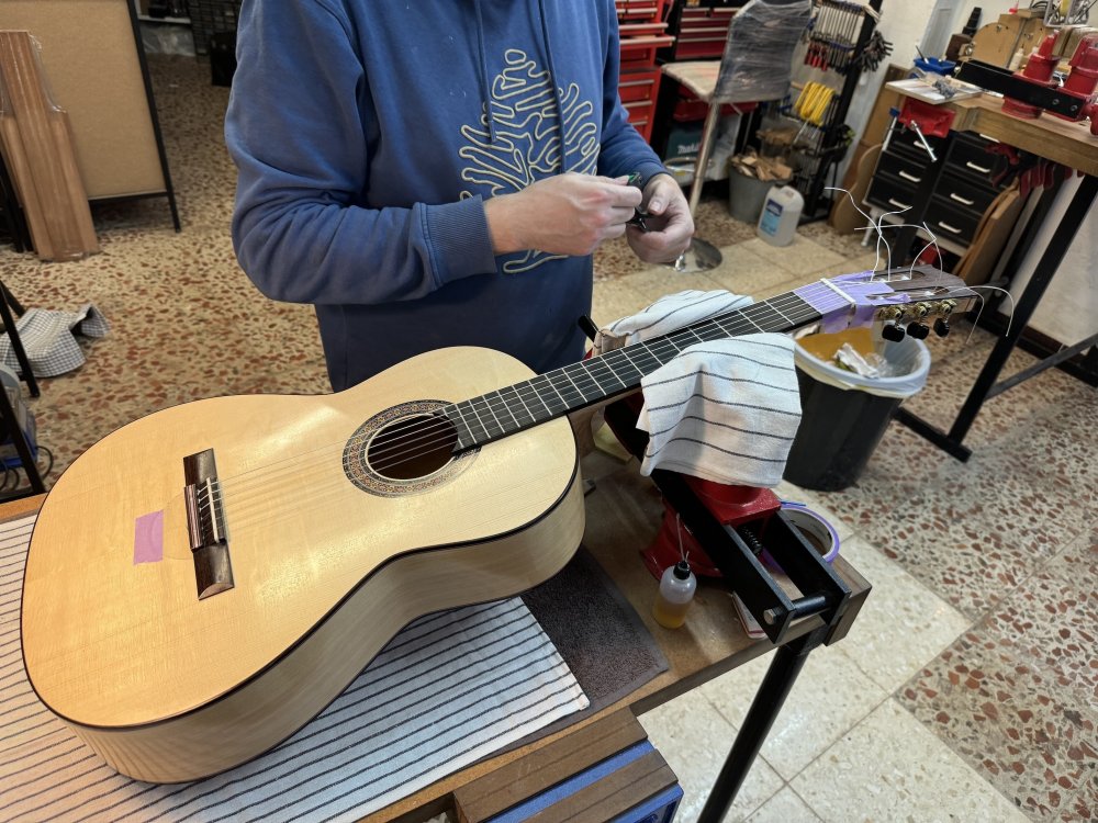 Paco Chorobo adjusting the string action on Ivan's guitar